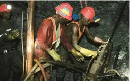  ?? THEMBA HADEBE/AP 2014 ?? Miners work in the South Deep gold mine south of Johannesbu­rg. South Africa saw its overall mining profits fall more than $5 billion in the last financial year.