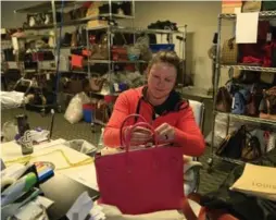  ?? DAVID BROOKS/SAN DIEGO UNION-TRIBUNE/TRIBUNE NEWS SERVICE ?? Fashionphi­le employee Danielle Whited registers a Hermes Epsom Candy Birkin bag that was sold to the Carlsbad, Calif., location.