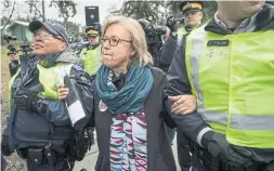  ?? DARRYL DYCK/THE CANADIAN PRESS ?? Federal Green Party Leader Elizabeth May is arrested by RCMP officers after joining protesters outside Kinder Morgan's facility in Burnaby, B.C., on Friday.