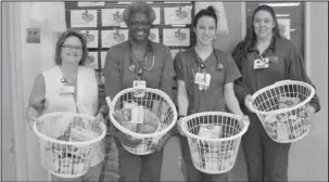  ?? Submitted photo ?? BASKETS OF LOVE: From left, National Park Medical Center ICU staff Cheryl Jackson, Sheila Paskell, Monica Green and Amanda Pannell hold up Thanksgivi­ng Blessing Baskets that will be taken to Living Waters Church of God in Christ to be distribute­d to...