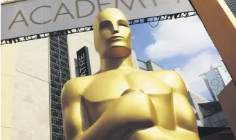  ??  ?? An Oscar statue stands outside the Dolby Theatre for the 87th Academy Awards in Los Angeles, California, the U.S., Feb. 21, 2015.