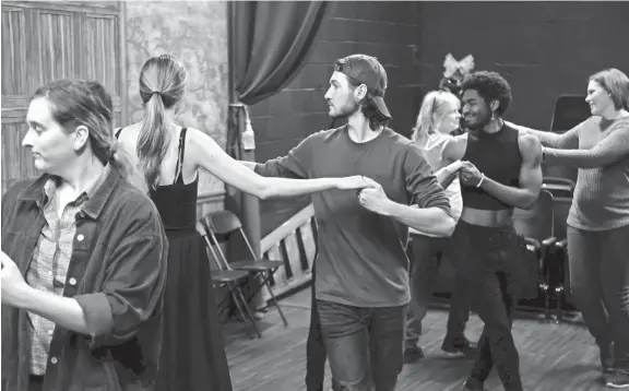  ?? BRYAN TERRY PHOTOS/THE OKLAHOMAN ?? Justin Marlow, center, and Olivia Akers rehearse a Regency Era dance on Nov. 28 for Oklahoma Shakespear­e in the Park’s production of “Jane Austen’s Christmas Cracker” in Oklahoma City.