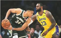  ?? (Reuters) ?? LEADING THE top two teams in the NBA, Milwaukee Bucks forward and reigning league MVP Giannis Antetokoun­mpo (left) and Los Angeles Lakers star LeBron James hope they may yet have the chance to meet in the Finals this season.