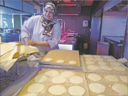  ?? Teresa Dovalpage ?? A baker in Egypt makes ‘aish baladi,’ also known as bread of life, that is similar to the beloved tortilla in New Mexico.