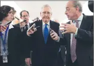  ?? AP/J. SCOTT APPLEWHITE ?? Senate Majority Leader Mitch McConnell, R-Ky., is surrounded by reporters Thursday as Republican­s work to pass their sweeping tax bill on Capitol Hill in Washington.