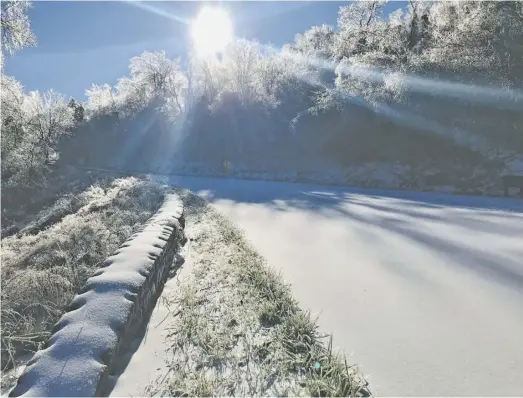  ??  ?? A solid sheet of ice and snow seen here Friday morning on Skyline Drive shut down the popular roadway from Wednesday night through the weekend.