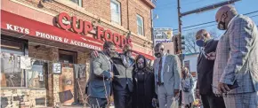  ?? KEREM YUCEL/AFP VIA GETTY IMAGES ?? George Floyd’s family and family lawyer Ben Crump, right, make a March 12 visit to a memorial at the site where Floyd died.