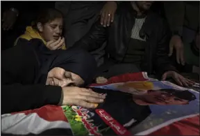  ?? FATIMA SHBAIR — THE ASSOCIATED PRESS ?? Mohammed al-shaer’s mother mourns on his coffin during his funeral in Rafah, in the southern Gaza Strip, on Sunday.