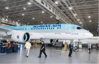  ?? CP FILE PHOTO ?? Bombardier employees work on CSeries 300 jets at the company’s plant in Mirabel, Que., on Sept. 28. Bombardier Inc. faces whopping duties of almost 300 per cent to export its CSeries commercial jet into the American market after the U.S. Department of...