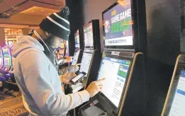  ?? KIM HAIRSTON | THE BALTIMORE SUN ?? Sean Tyler, of Hanover, places bets in Sports & Social Maryland. The FanDuel Sportsbook launched sports betting at Live! Casino & Hotel on Friday.