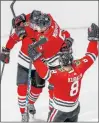  ?? JEFF VINNICK/GETTY ?? Connor Murphy (5) is congratula­ted by his teammates Jonathan Toews and Dominik Kubalik (8) after scoring a go-ahead goal against the Edmonton Oilers.