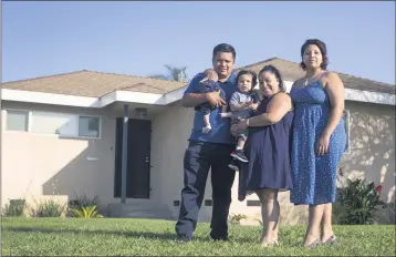  ?? PHOTO BY DREW A. KELLEY ?? Jean Silvestre, left, and Elvia Del Cid hold her niece and nephew, Gianna and Leonardo, with her daughter Kat Aquino outside their new house in Whittier in May. After getting outbid on six other houses, the couple decided to “overbid.”