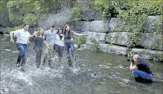  ?? CLIFFORD SKARSTEDT/EXAMINER ?? Artist Esther Vincent takes photos of the Piper family, including Tim, left, Maggie, Jack, Cassia and Pauline Harder, for an Artsweek photo shoot titled Going Down To Jackson on Tuesday at Jackson Creek near McDonnel St. in Peterborou­gh, Ont. Selected...