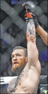  ??  ?? Conor McGregor gets his arm raised after needing only 40 seconds to beat Donald “Cowboy” Cerrone on Saturday night at T-Mobile Arena.