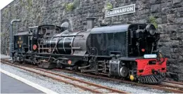  ?? CHRIS PARRY ?? Ex-South African Railways ‘NG/G16’ No. 87, resplenden­t in SAR black, runs round at Caernarfon during the Welsh Highland’s first day of post-lockdown services on August 18.