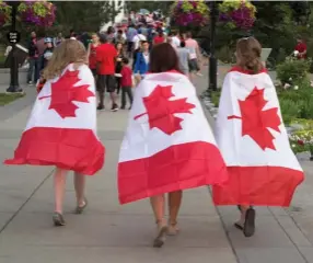  ??  ?? Children in Calgary celebrate Canada Day in 2015. While Canadians often unite for causes and celebratio­ns, politicall­y it is difficult to identify Canada as a nation.