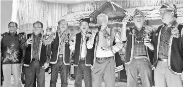  ??  ?? Manyin (third right) leads the Gawai toast as he is joined by (from left) Penghulu Dennis Gamin, Tuah, John David, Nicholas, John Ilus and Charlie.