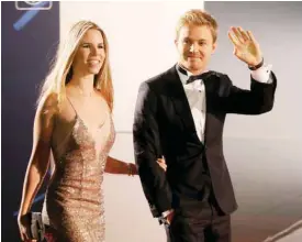  ??  ?? VIENNA: Nico Rosberg, 2016 F1 World champion, right, arrives with his wife Vivian Sibold at a FIA gala at Hofburg palace in Vienna, Austria, Friday. Current Formula One World Champion Nico Rosberg announced Friday that he will retire from Formula One...