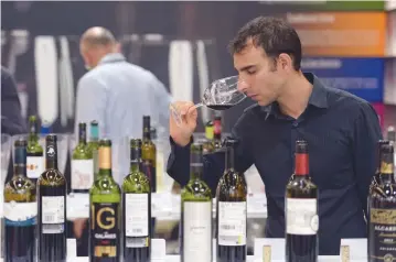  ?? AFP ?? A VISITOR tastes wine at the Vinexpo, the world’s biggest wine fair, in Bordeaux, southweste­rn France, on June 19.