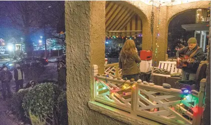  ?? HANNAH RUHOFF/STAFF ?? ABOVE: Tom Sanley, right, and The Bandshes’ Zoe Chatfield perform on an apartment balcony Saturday as a part of a porch music festival dubbed “Porchella”in Norfolk’s Ghent neighborho­od. BELOW: Rebecca Gilmore plays a cello out of the back of a car.