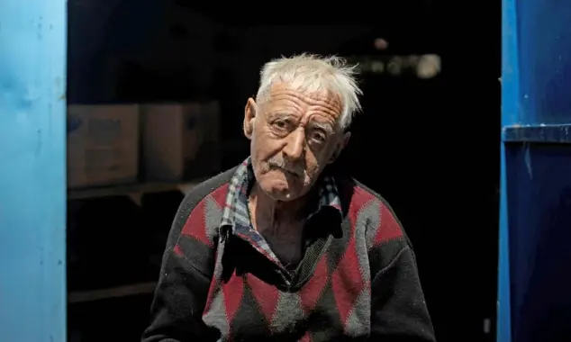  ?? Stephen Zenner/The Blade ?? Vitalli Vasylets, 67, sits in front of his garage in Katiuzhank­a, Ukraine, on June 3. Vasylets has been visited by Russians three times and had his car damaged. “There is no future here. It’s heartbreak­ing to see my country like this,” he said. But he sees no point in fleeing the motherland he loves.