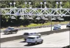  ?? Elise Amendola / Associated Press ?? Cars pass under toll sensor gantries hanging over the Massachuse­tts Turnpike in Newton, Mass in August 2016.