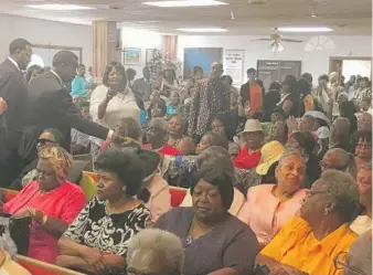  ?? ADAM THORP/SUN-TIMES ?? Before giving money to people in line, Willie Wilson waded into the audience on Sunday at Old Friendship Missionary Baptist Church to hand money directly to people who could not stand in line.