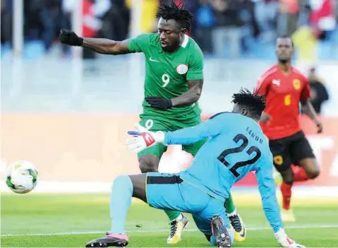  ?? PHOTO: CAF.COM ?? Eagles’ Anthony Okpotu tries to beat Angolan goalkeeper, Landu, in the quarterfin­al match of the CHAN’S tournament held at the Stade Ibn Batouta in Tangier, Morocco...yesterday.