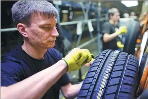  ?? ANDREY RUDAKOV / BLOOMBERG ?? A worker inspects automobile tires at the Continenta­l AG tire plant in Kaluga, Russia.