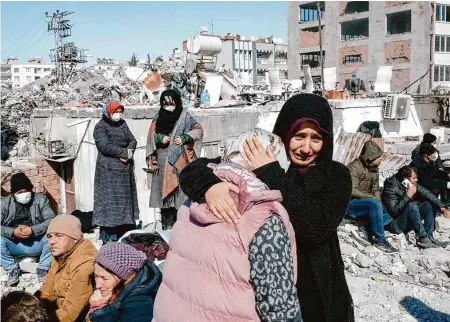  ?? Photos by Emin Ozmen/New York Times ?? People mourn after rescuers on Tuesday found the body of a relative in a collapsed building in Adiyaman, Turkey.