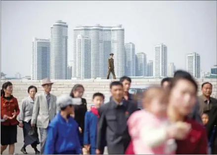  ?? ED JONES/AFP ?? A soldier stands by as people queue to visit a flower show in Pyongyang on April 16.