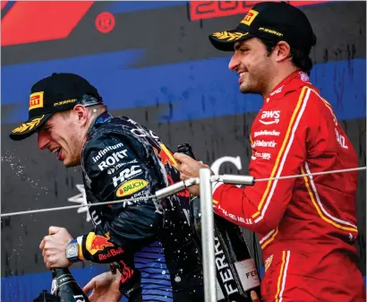  ?? ?? Carlos Sainz ( right) pops champagne alongside Max Verstappen after the Red Bull driver’s win in Japan