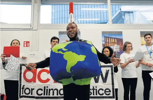  ?? Picture: REUTERS/KACPER PEMPEL ?? CREATING AWARENESS: Environmen­tal activists display signs inside the venue of the Cop24 UN Climate Change Conference 2018 in Katowice, Poland on December 4.