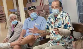  ?? Pam Panchak/Post-Gazette ?? Jim Howels, right, talks about his struggles through the COVID-19 quarantine while Arnette Augustine, 94, and Jim Boyle, 75, listen at the Mount Washington Senior Community Center on Thursday.