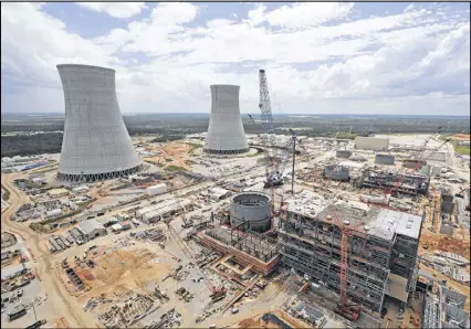  ?? GEORGIA POWER ?? The cooling towers for Plant Vogtle reactors 3 and 4 rise above the constructi­on sites.