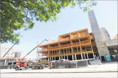  ?? Michael Cummo / Hearst Connecticu­t Media file photo ?? A mixed-use developmen­t goes up at Tresser Boulevard and Greyrock Place in June. Board of Representa­tives members sparred over raising building-permit rates this week.