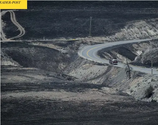  ?? DARRYL DYCK / THE CANADIAN PRESS ?? Firefighte­rs drive through an area scorched by wildfires on the side of a mountain in Ashcroft, B.C., on Sunday. The province has begun closing provincial parks in affected areas and issued a campfire ban, as outgoing Premier Christy Clark warned the...