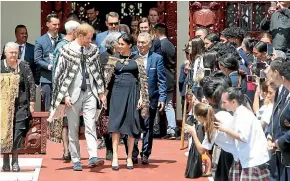  ?? GETTY IMAGES ?? Prince Harry, Duke of Sussex, and Meghan, Duchess of Sussex, depart the Tamatekapu­a meeting house and meet children at Te Papaiouru Marae in Rotorua yesterday.