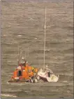  ?? Photograph: Andrew Williams ?? The Troon RNLI lifeboat alongside the casualty vessel off Ardrossan.