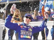  ?? Derik Hamilton / Associated Press ?? Kyle Busch celebrates in Victory Lane after winning at Pocono Raceway in Long Pond, Pa., on Sunday.