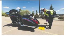  ?? GREG SOUTHAM ?? Const. Trevor Henderson of the Edmonton Police Service tests the noise level of a bike. Loud exhaust systems are under attack in many jurisdicti­ons, writes David Booth.