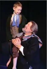  ?? SUBMITTED PHOTO — YOCUM INSTITUTE FOR ARTS EDUCATION ?? Ebenezer Scrooge, holding Tiny Tim, learns the true meaning of Christmas in “A Christmas Carol” presented at the Yocum Institute’s Schumo Theater Dec. 12 to 14. Depicted in the photo is Doug Stenberg playing the role of Ebenezer Scrooge and Paul Head playing the role of Tiny Tim.