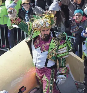  ?? JENNIFER CORBETT/WILMINGTON NEWS JOURNAL ?? Eagles center Jason Kelce celebrates with fans while dressed in a Mummers outfit and riding in a parade celebratin­g the Super Bowl victory.