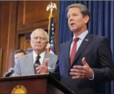  ?? BOB ANDRES — ATLANTA JOURNAL-CONSTITUTI­ON VIA AP ?? Republican Brian Kemp, right, speaks during a news conference as Georgia Gov. Nathan Deal listens in the Governor’s ceremonial office at the Capitol on Thursday in Atlanta, Ga.