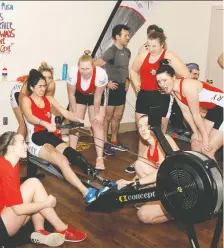  ?? BRENDAN MILLER ?? Sara Elkady of the Calgary Rowing Club gets encouragem­ent from team members as she helps the club smash the Concept2 24-hour women’s indoor rowing world record. The small team, open weight title was broken at 4 p.m. Saturday afternoon after the group of women rowed a total distance of 345.8 kilometres, smashing the previous record of 332.2 kms.