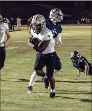  ?? TIM GODBEE / For the Calhoun Times ?? Calhoun’s Jonkell Tolbert runs past multiple Coahulla Creek defenders for a touchown on Friday.