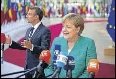 ?? BLOOMBERG ?? German Chancellor Angela Merkel (right) and French President Emmanuel Macron speak to the media upon their arrival at the EU leaders summit in Brussels on Thursday.