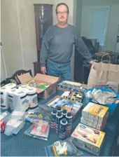  ?? STAFF PHOTO BY MARK KENNEDY ?? Doug Ownbey, of Brainerd, assembles backpacks filled with provisions for homeless people.