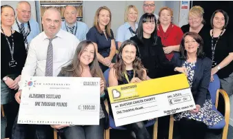  ??  ?? Cheque this Council staff with the cheques for the Beatson and Alzheimer Scotland and another went to St Andrew’s Hospice