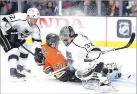  ?? Mark J. Terrill ?? DUCKS WINGER David Perron, center, scores a f irst- period goal against Kings goaltender Jonathan Quick as Marian Gaborik arrives too late.